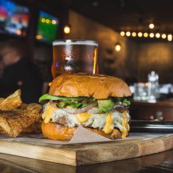 Arch City Tavern signature dishes  Arch City Burger, Braised Beef Short Ribs, Truffle Fries, various flatbreads, Mussels.